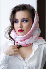 PPortrait of attractive beautiful fashionable young woman dressed in the style of 1980s, with bright fancy make up, pink scarf, glasses. 80s inspiration and vibes