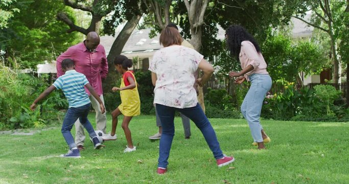 Animation of happy african american family playing football in garden