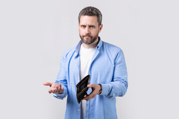 shrugging broke man with wallet isolated on studio background. broke man with wallet