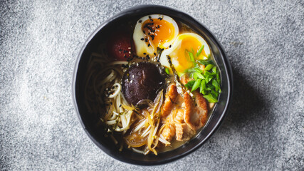 Asian food. Soup with mushrooms, seafood and eggs in a stylish plate. Restaurant serving.