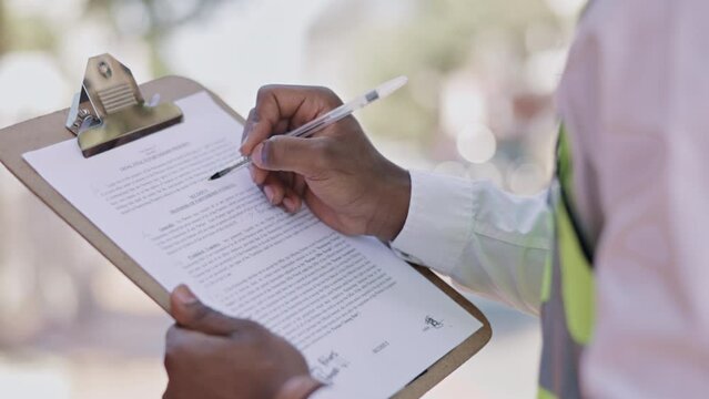 Black man, hands and writing on clipboard for checklist, contract or inspection in the city. Hand of African American male ticking, signing or reading information for construction or maintenance