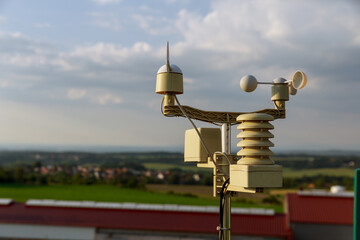 Meterological weather station wind meter anemometer on sky background. - obrazy, fototapety, plakaty
