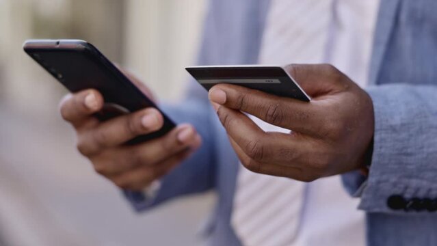 Black man, hands and phone with credit card in ecommerce, online shopping or banking in city. Hand of African American businessman typing on smartphone for internet purchase, bank app or transaction