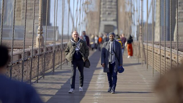 Walking over Brooklyn Bridge New York on a sunny day - travel photography