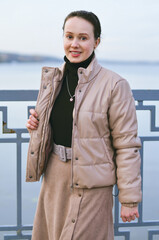 A beautiful young woman carelessly walks the streets of the city