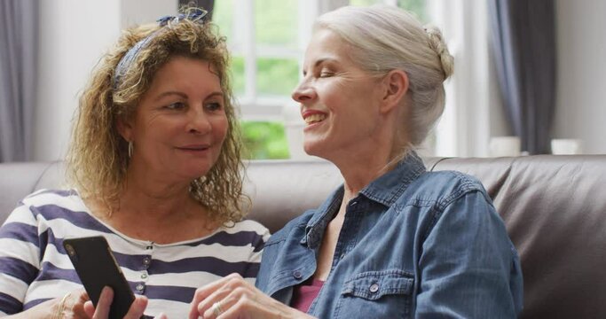 Animation of happy diverse female senior friends using smartphone