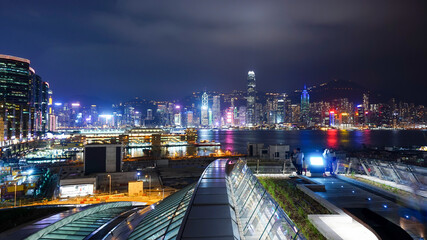 Fototapeta na wymiar Hong Kong Victoria Harbour's night skyline from roof garden of West Kowloon railway station