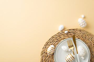 Easter celebration concept. Top view photo of plates cutlery white and gold easter eggs on rattan serving mat on isolated beige background with copyspace