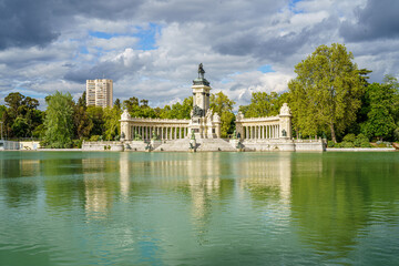 Fototapeta na wymiar Monument to King Alfonso XII in the pond of the Retiro park in the city of Madrid, during a sunny spring day with blue sky