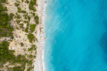 Fototapeta na wymiar Straight down view on waves on rocky shore by Bunec Beach area in Summer 2022, Albania