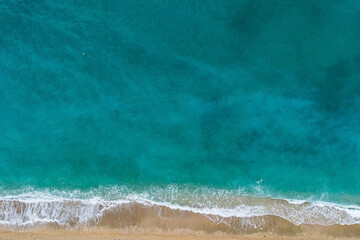 Straight down view on waves and shore of small stones by Bunec Beach area in Summer 2022, Albania