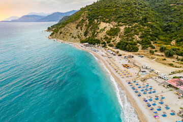 Aerial view of Bunec Beach area with beach umbrellas in Summer 2022, Albania - obrazy, fototapety, plakaty