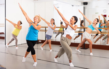 Dance class for adult people, positive young and mature women training in dance studio