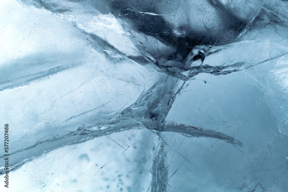 Wall mural Abstract ice background. Blue background with cracks on the ice surface