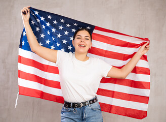 Portrait of positive young woman with the flag of USA