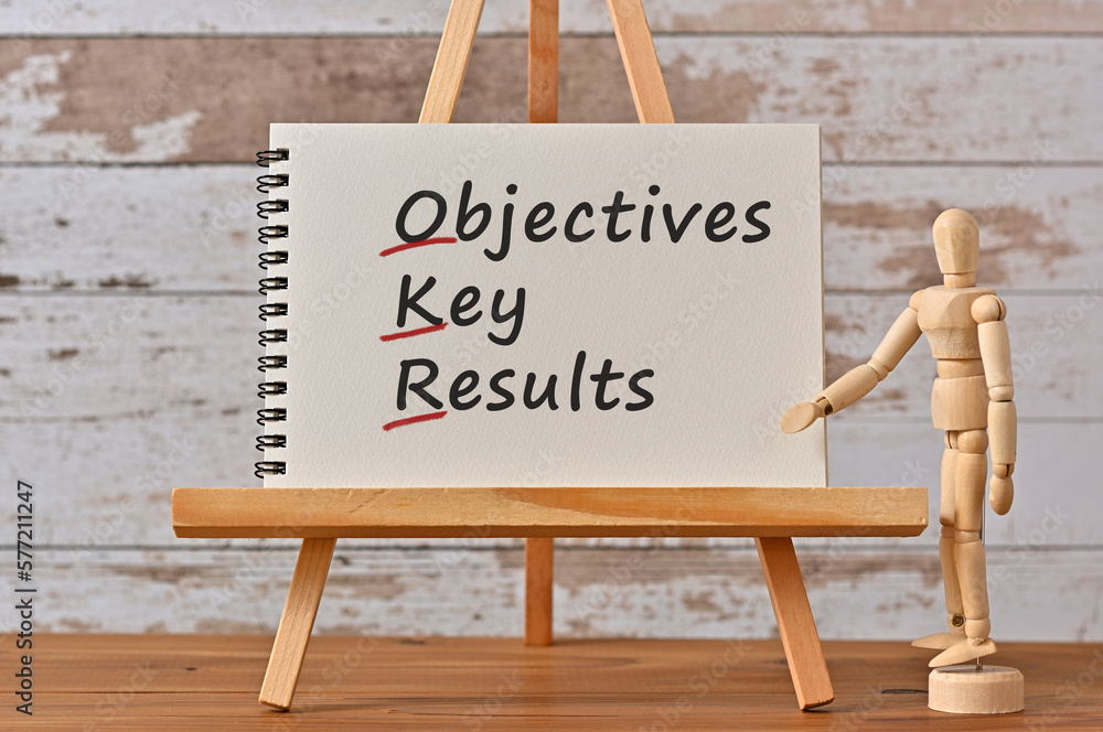 Poster there is notebook with the word objectives key results. it is an eye-catching image.