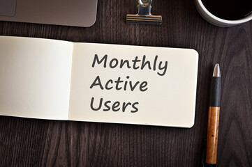 There is notebook with the word Monthly Active Users. It is an eye-catching image.