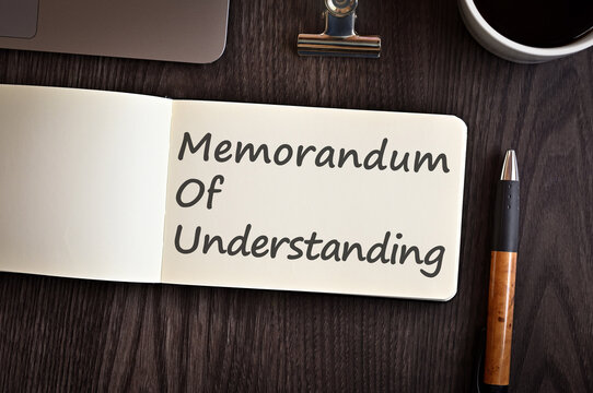 There is notebook with the word Memorandum of Understanding. It is an eye-catching image.