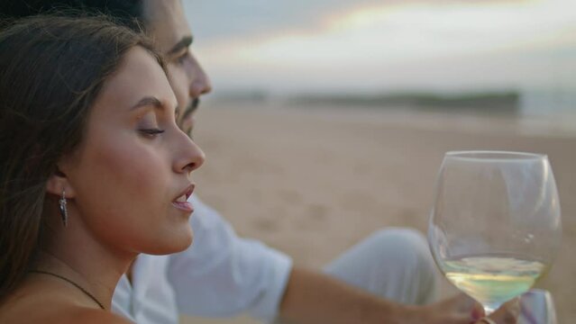 Sensual woman drinking wine glass beach closeup. Young newlyweds celebrate date