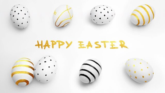 Top view. 4K video. Happy Easter greeting card. Chicken egg with golden striped pattern, black dotted pattern, lines on white background. Handwritten text congratulations. Copyspace. Farm food. Banner