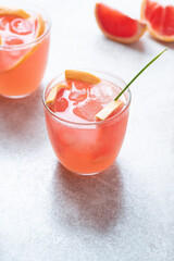 Pink Paloma with grapefruit  and tequila on a fresh stone background. Fruity light cocktails,  eco friendly  natural style, soft pastel colors
