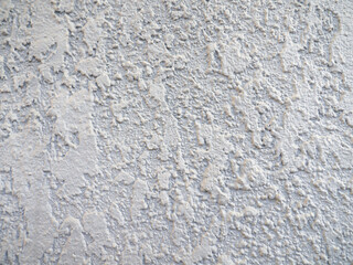 Rough light surface. Background from a stone wall. Cement stains. House cladding.