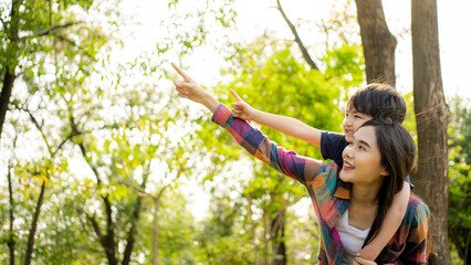 Happy Asian mother having fun with her son outdoors - Family and love concept. Mother’s day celebration.