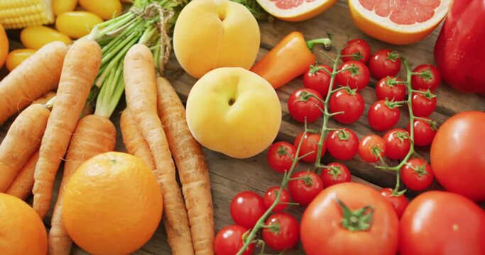 Video of fresh fruit and vegetables over wooden background