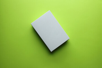 Blank package box on green background with copy space