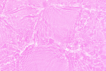 Defocus blurred transparent pink colored clear calm water surface texture with splashes and bubbles. Trendy abstract nature background. Water waves in sunlight with copy space. Purple watercolor shine