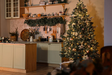 Stylish kitchen with Christmas tree and festive decor. Interior design