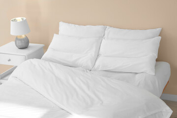 White soft pillows on cozy bed in room