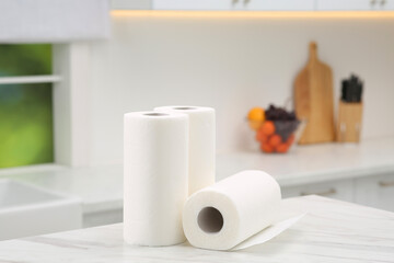 Rolls of paper towels on white marble table in kitchen