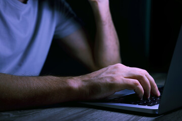 Man using computer at night, closeup. Internet addiction