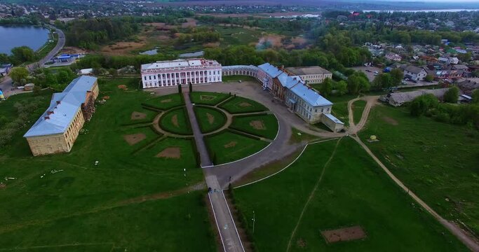 Flight over historical palaces in Tulchin, Vinnytsia region, Ukraine. Top vie wof the old residence and surrounding inhabited landscape.