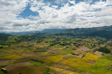Naklejka premium Aerial drone of Agricultural land and mountains with green forest. Philippines.