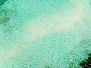 Aerial view of turquoise lagoon surface on atoll and coral reef, copy space for text. Balabac,...