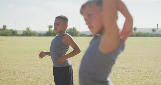 Video of focused diverse boys practicing yoga on sunny day