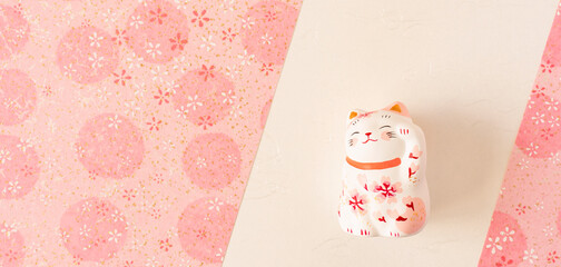 Background material to celebrate spring. Sakura Japanese paper and cat brings luck. Spring,...