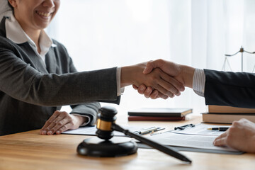 Lawyers shake hands with business people to seal a deal with partner lawyers. or a lawyer discussing contract agreements, handshake concepts, agreements, agreements