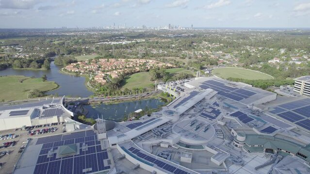Massive Shopping Mall Robina Town Centre With Rooftop Solar Systems In Robina Suburb, Queensland, Australia. aerial sideways