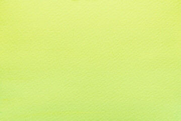 Bright green watercolor paint on paper background.