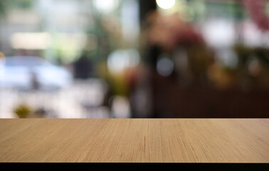 Empty wooden table in front of abstract blurred background of coffee shop . can be used for display or montage your products.Mock up for display of product