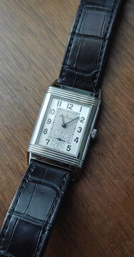 BANGKOK, THAILAND - MARCH 3 : Jaeger leCoultre Reverso, rectangle classic model, blued steel hands with alligator strap, put on table in Bangkok, Thailand, on March 3, 2023.