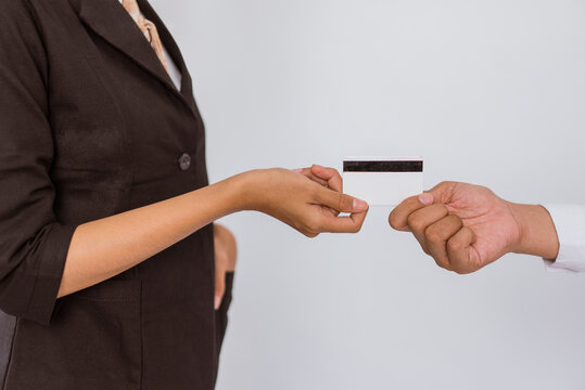 close up of the hand of the asian woman in formal outfit giving the blank card on isolated background