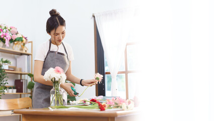 Banner with blank copyspace, Flower shop concept, Female florist trim stems of pink gerbera by scissor for arranging in vase