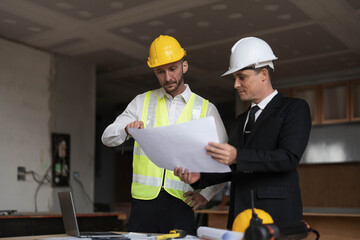 Diverse Team of Specialists Use Laptop on Construction Site. Real Estate Building Project with Engineer Investor and Businessman Checking Area, working on Civil Engineering, Discussing Strategy Plan