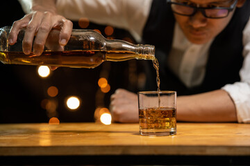 Barman pouring whiskey whiskey glass beautiful night