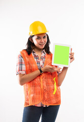 a beautiful architect in safety waistcoat standing with smile and showing the digital tablet with green screen on isolated background