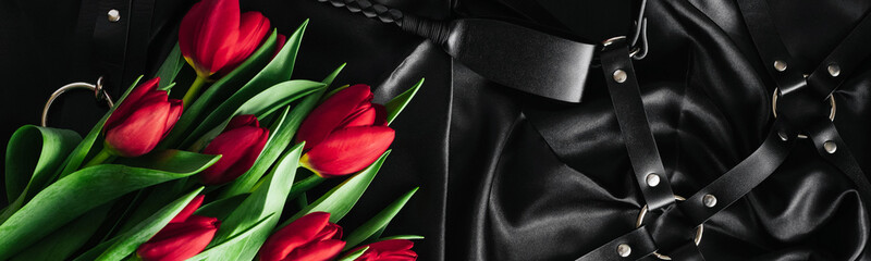 Various sex toys set on a black background. The view from the top. Tulips. Valentines day....